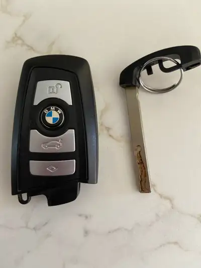 Selling a used 2011 BMW key fob with some signs of wear and tear as shown in the photos. Looking to...