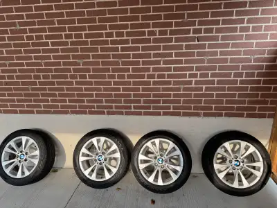 Set of 4 BMW OEM 17” rims and tires with over 75% thread.