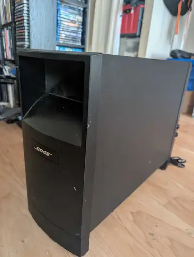Bose Acoustimass 6 - subwoofer (bass module) and 3 cube speakers with 2 stands. The bass module is t...
