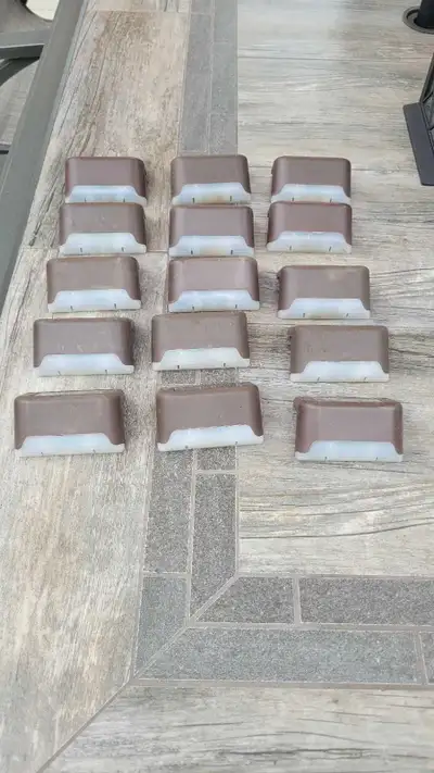 23 Brown solar deck lights Can be screwed or dble sided adhesive tape for mounting Lights will turn...