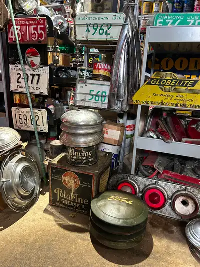 Large selection of miscellaneous antiques. Tailgates Oil cans License plates Signs Car parts Hubcaps...