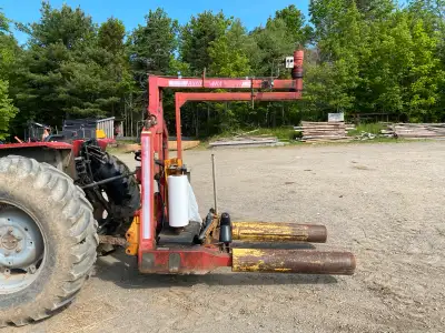Older bale wrapper can be seen working can pick the bales up out of the field wrap them and then set...