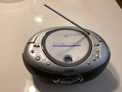 Coby CX-CD236 portable CD player with AM/FM radio. Compat design. Easy to carry around. Preowned, in...