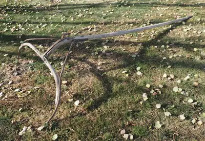 Antique farm machinery for a yard decoration. It's an attachment to hook up a hay cutter to a team o...