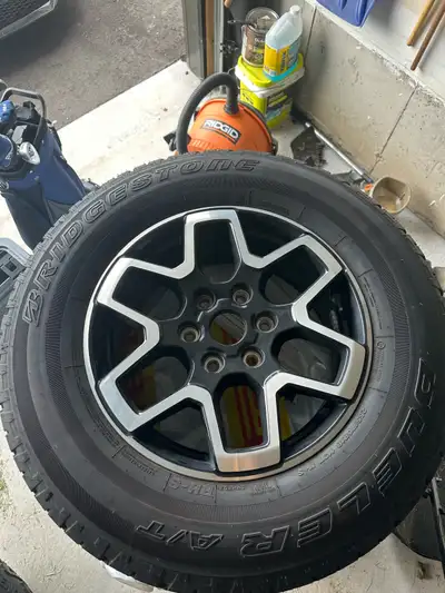 Up for sale is a set of Ford Bronco 255/70R18 Bridgestone Dueler A/T tires mounted on rims, offering...