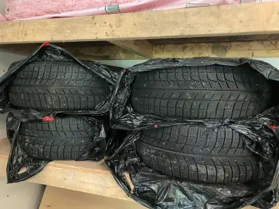 Offering a set of four Michelin X-Ice winter tires mounted on steel rims, size 205/55R16, perfect fo...