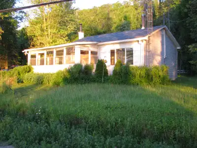 Who's feeling lucky? Small 3-season cottage right on Lake Cayamant with 255 feet of frontage on a on...