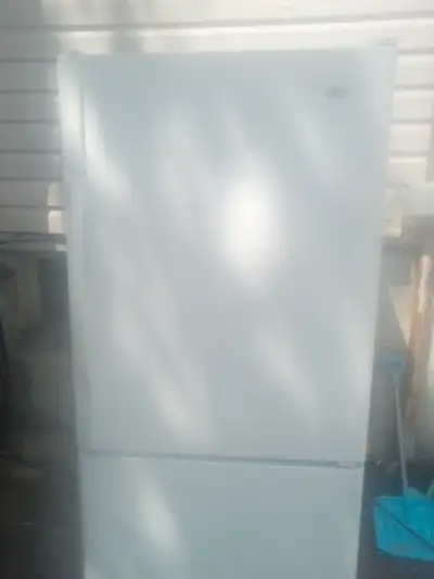 Maytag full-size refrigerator...white in colour..freezer on bottom....a few minor dents and dings bu...