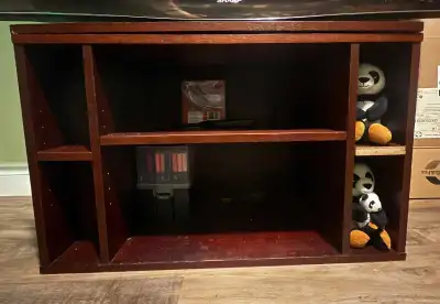 Sturdy and dark wood shelving unit perfect for a media center, bookshelf, or entryway storage. Comes...