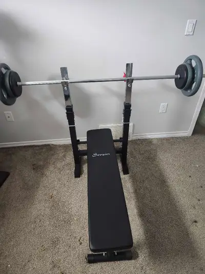 Folding bench press with 110lb in weights., View more