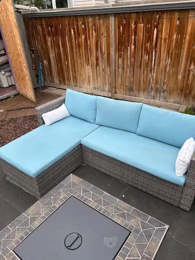 Patio sectional with glass side table. Synthetic wicker is in fantastic condition, cushions have som...