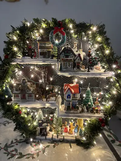 This is a charming hand crafted Christmas village display, all set up with everything seen in the pi...