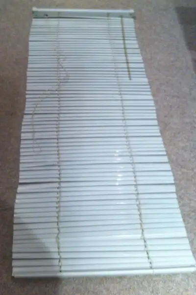 Used mini blind in working order. Size 24" W x 60" L.