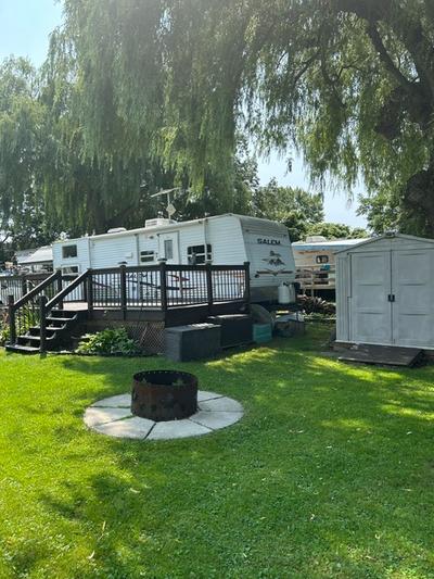 This 28' trailer features a large power slide out to make for a roomy common area. It comes with a l...