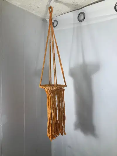 Orange Macrame Plant Hanger. NEW 30” long Brand new Can fit up to a 6” pot $20 Cash or E-transfer Ce...