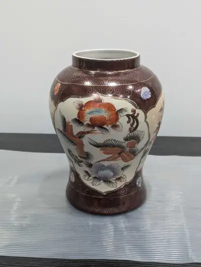 This is a vintage porcelain vase with a floral and bird design. It is approximately 9 inches tall an...