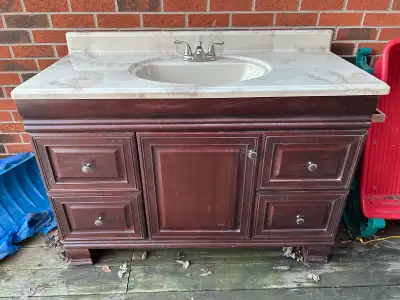 Bathroom vanity, 48’’ wide 22” deep and 3’ tall. Faucet works great vanity in decent shape top is go...