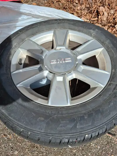 Four GMC Aluminum rims with center caps comes with tires 235/65 r17).