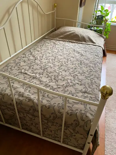 Twin Bed with second (pop-up) bed underneath. Decorative railing on 3 sides, cream colour with brass...