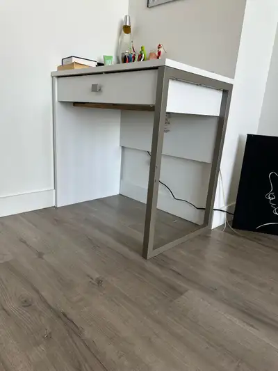 White desk with metal leg/side bar, l have an extra one available. Good condition