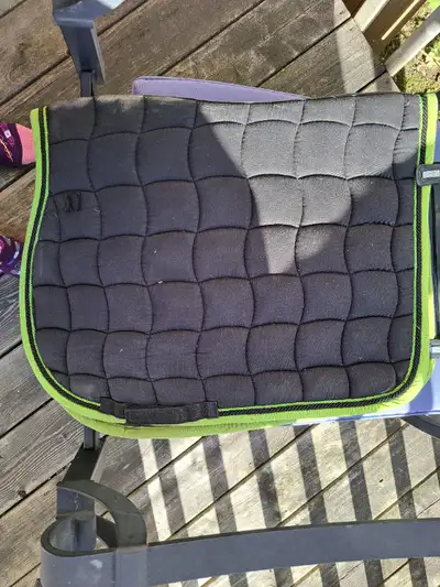 Black Lami-Cell all-purpose saddle pad with lime green trim. Full size. Contoured for better fit ove...