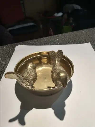 Selling vintage solid brass bowl over 4" in diameter with two birds sitting on the edge. Nice home d...