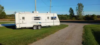 Travel Lite Trailer great conditions. Its 26 feet with a slide out on one side. Full Queen bed in fr...