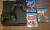 PS4 with controllers and games.