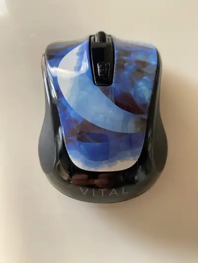 This is a Vital wireless mouse with a unique blue design. It is in used condition, but still works p...