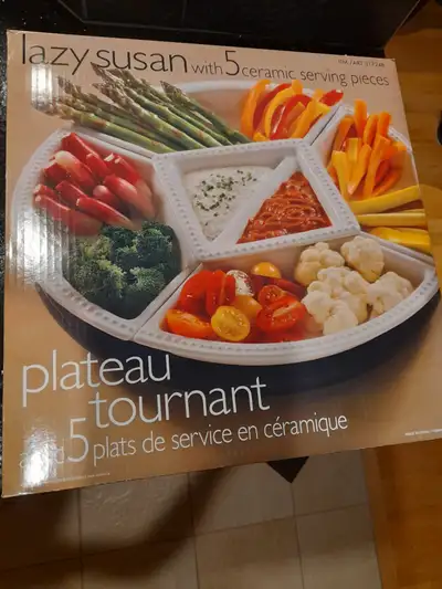 This Large Lazy Susan has a wooden base with 5 ceramic serving pieces and was only used twice. The d...