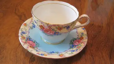 Aynsley England bone china cup and saucer, light blue center, flower border. on-line price from 40-1...