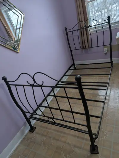 Twin bed with mattress and box spring and a few sheets, View more