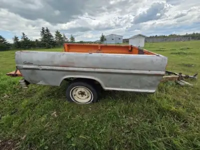 Older Ford pick up 8 foot truck box trailer. Sold as is. No lights. Good tires. Some rust. Floor nee...