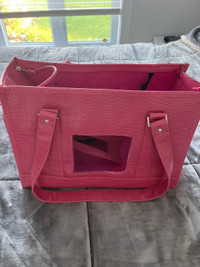 Pink dog carrying purse