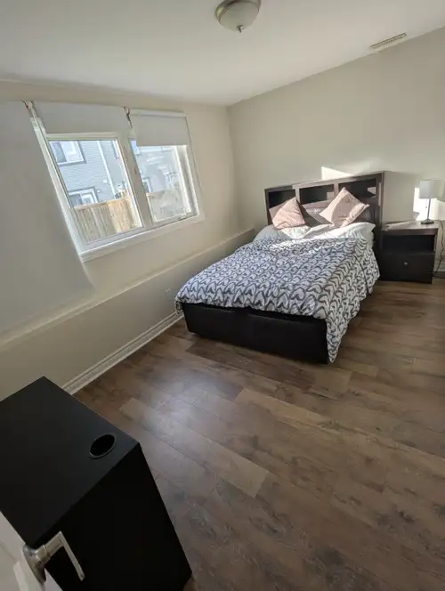 A beautiful, well-lit bedroom for rent in a walk-out basement with a shared unit kitchen in a quiet,...