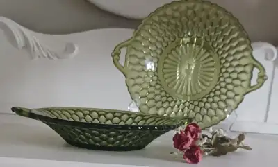 These green, depression, Indiana glass, bowls have 2 small handles, and a honeycomb pattern. They st...