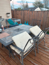 Well loved patio set with 5 chairs / cushions included .