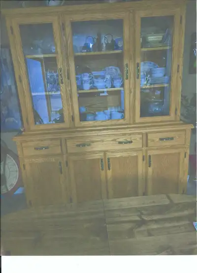 Solid oak China cabinet asking only $500.00 or best offer. Top section has glass doors, great for di...