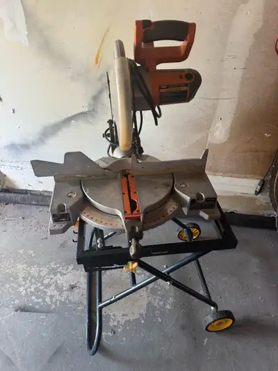 RIDGID 12” Compound Miter Saw in good working condition, mounted on a portable rolling Mastercraft s...