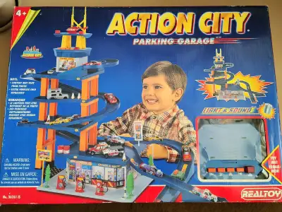 REALTOY Action City Parking Garage. Comes with all pieces in original box. Tested and working. Some...