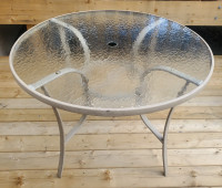 Round patio table with glass top.