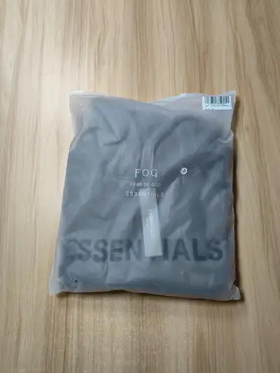 This Fear of God Essentials hoodie in size M is brand new and comes in its original packaging. It's...