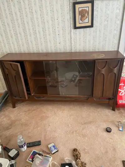 Wooden cabinet with sliding glass and hidden compartments