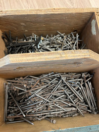 Lots of construction nails in a wooden box