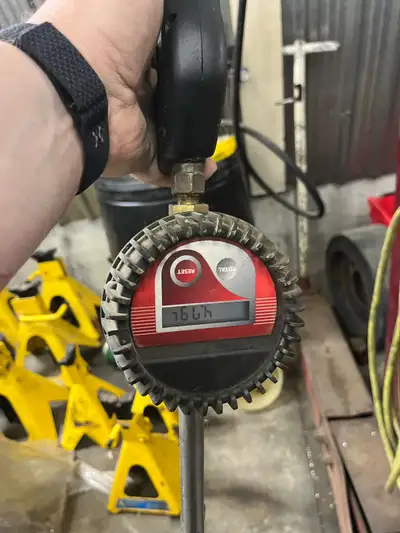 Bulk oil pump and hose reel with metering nozzle. Setup in a 55gal drum or tank to fill engines/hydr...