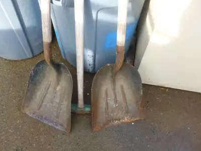 Scoop shovels and a sledge hammer., View more