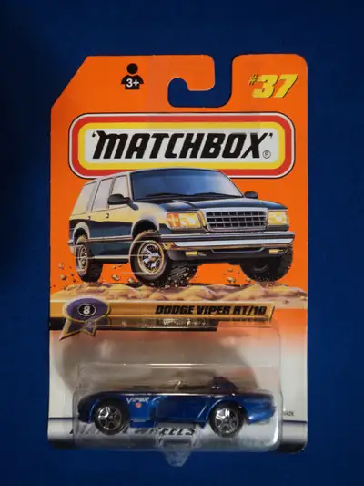 This blue Dodge Viper RT/10 has a decal that says Viper with the Dodge symbol below it on the side o...