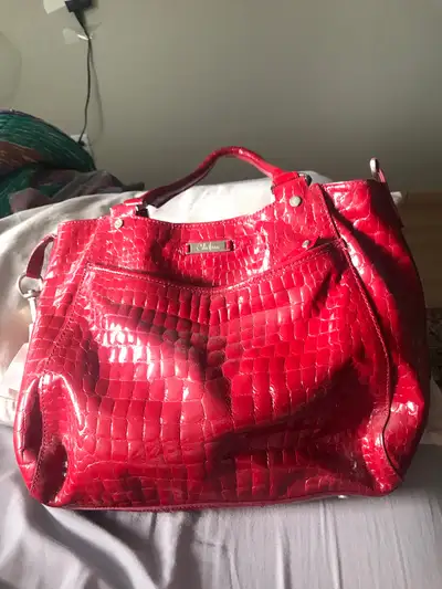 Check out this stylish Cole Haas branded purse in a vibrant red, perfect for adding a pop of colour...