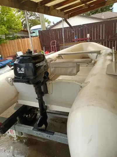 Z-Ray 500 inflatable boat with 2.6 HP four stroke APS motor. Motor may need carb cleaning. Trailer i...