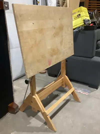 This sturdy wooden drafting table is perfect for artists, architects, and hobbyists looking for a re...